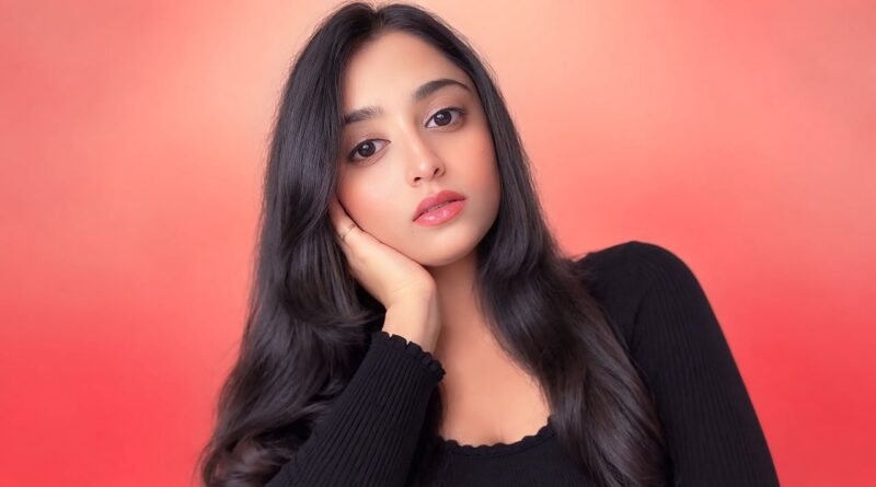 woman, portrait, young, black clothing, girl, soft light, light red background, beauty, pose, facial expression, model, attractive, long hair, friendly, pretty, beautiful, red tones, fashion, hair