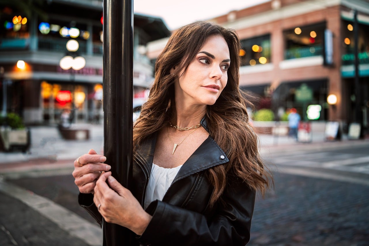 woman, portrait, city, fashion, style, urban, brunette, leather jacket, street lamp, autumn, surprised, jewelry, walking, outdoors, authentic, photography, modern, natural, trendy